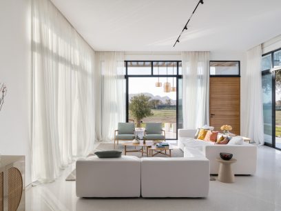 the interiors showcasing a living room with a predominately white color palette