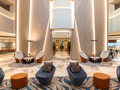 A lobby with chairs and tables at the sheraton