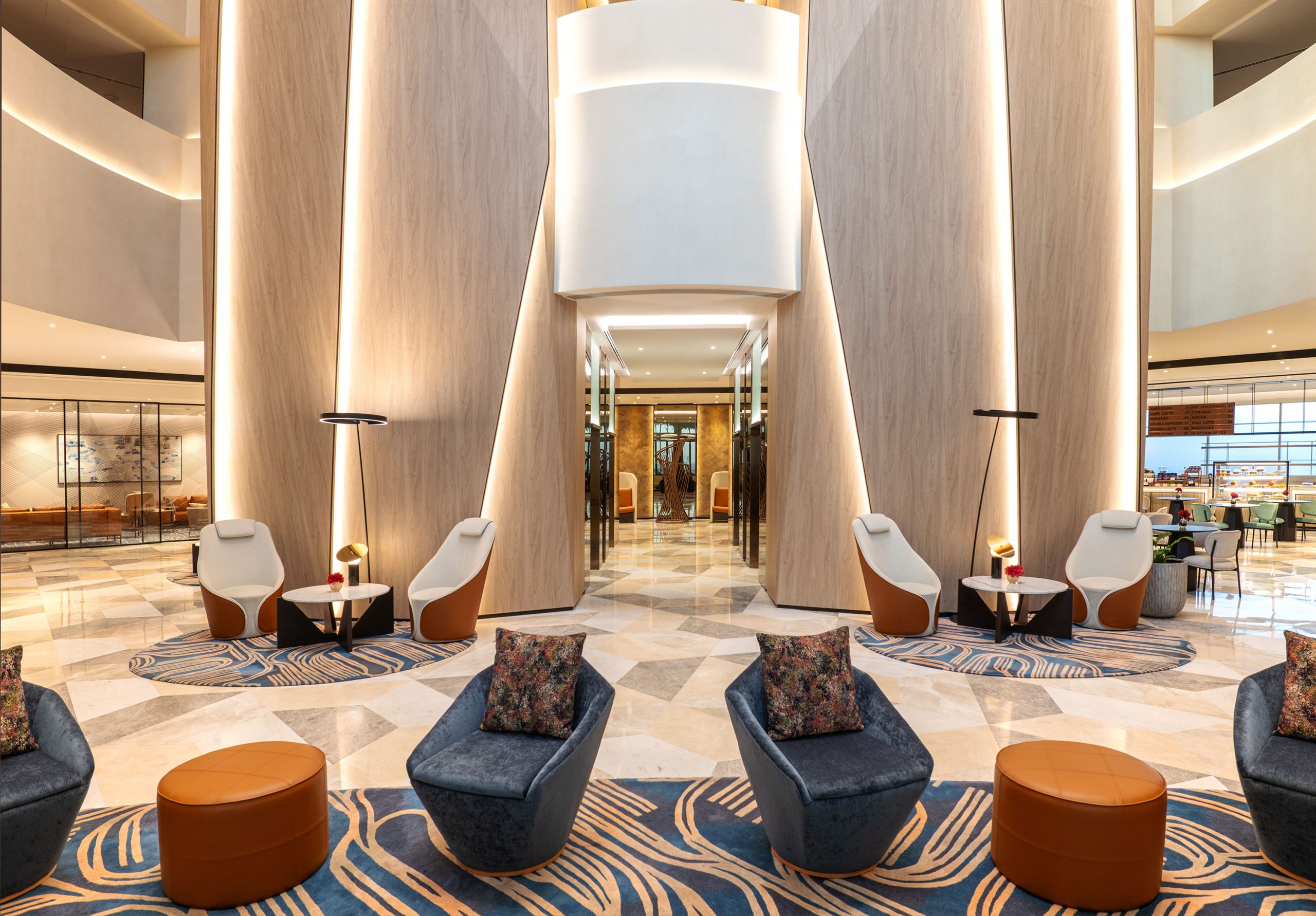 A lobby with chairs and tables at the sheraton